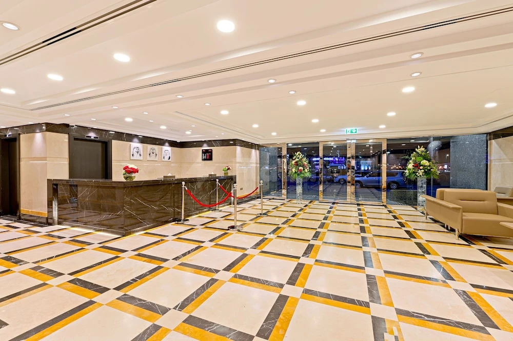 Marble lobby at TIME Moonstone Hotel Apartments, Fujairah, with geometric tiled flooring and reception desk