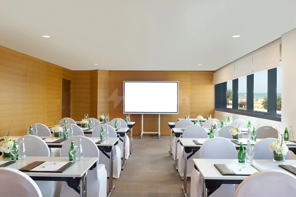 Conference room at Wyndham Garden Ajman Corniche, Ajman, with large screen and sea-view windows