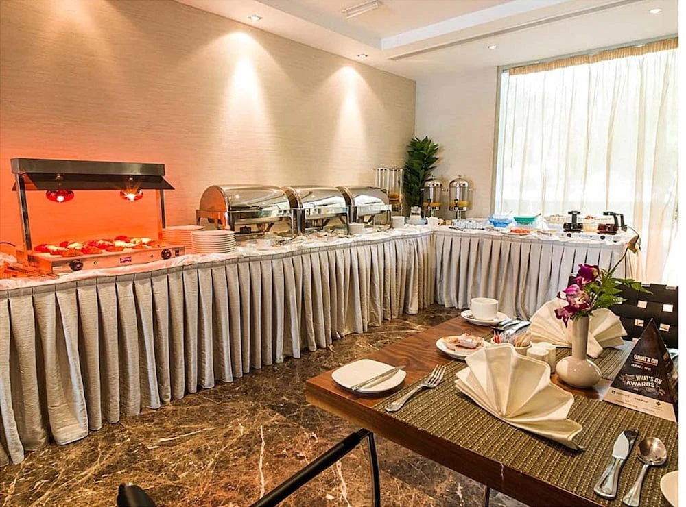 Buffet area at Executive Suites - Abu Dhabi, Abu Dhabi, with stainless steel chafing dishes and marble flooring