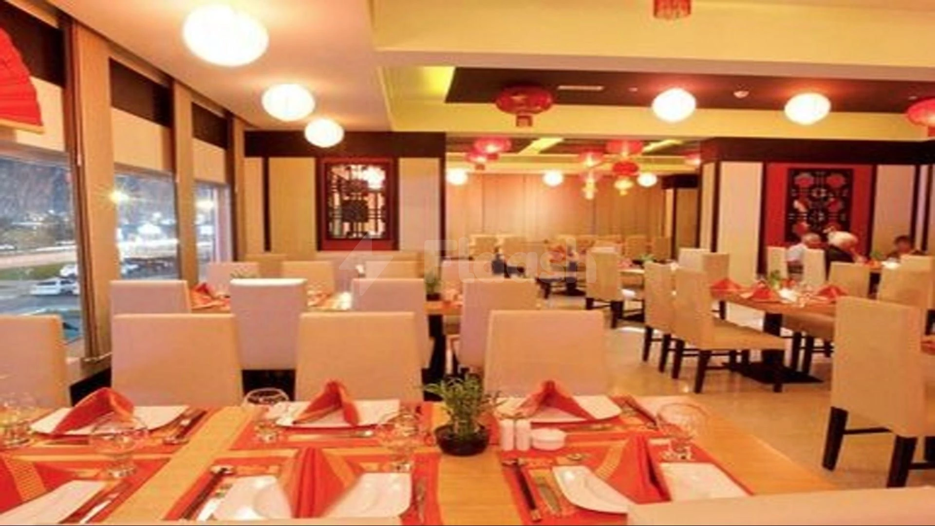 Dining area at Mangrove Hotel, Ras Al Khaimah, with red napkins folded into triangular shapes on tables