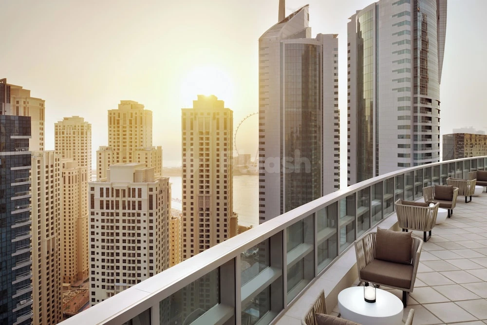 Rooftop terrace at InterContinental Dubai Marina, Dubai, featuring lounge chairs and city skyline views at sunrise