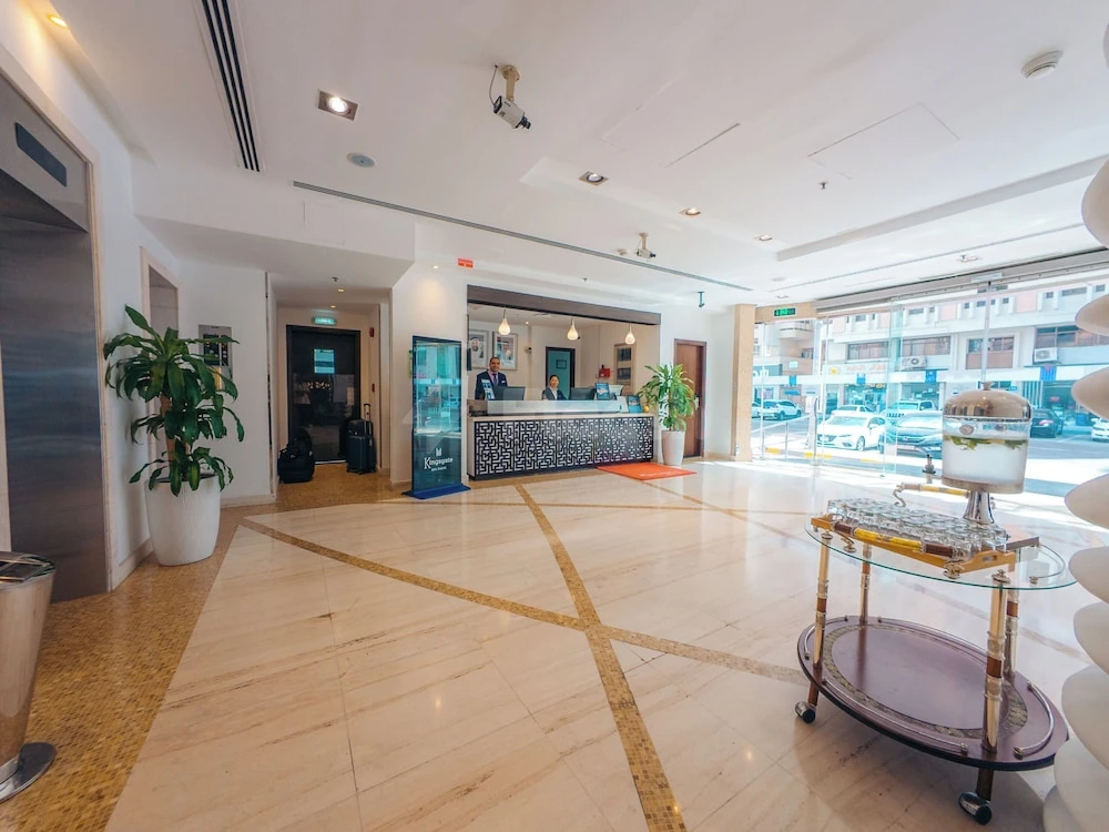 Lobby at Kingsgate Hotel Abu Dhabi By Millennium, Abu Dhabi, with marble flooring and large glass windows facing
