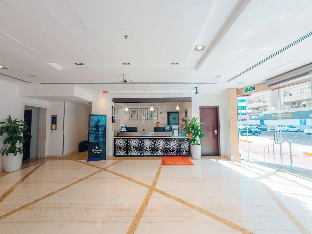 Marble lobby at Kingsgate Hotel Abu Dhabi by Millennium, Abu Dhabi, with geometric patterned reception desk and potted