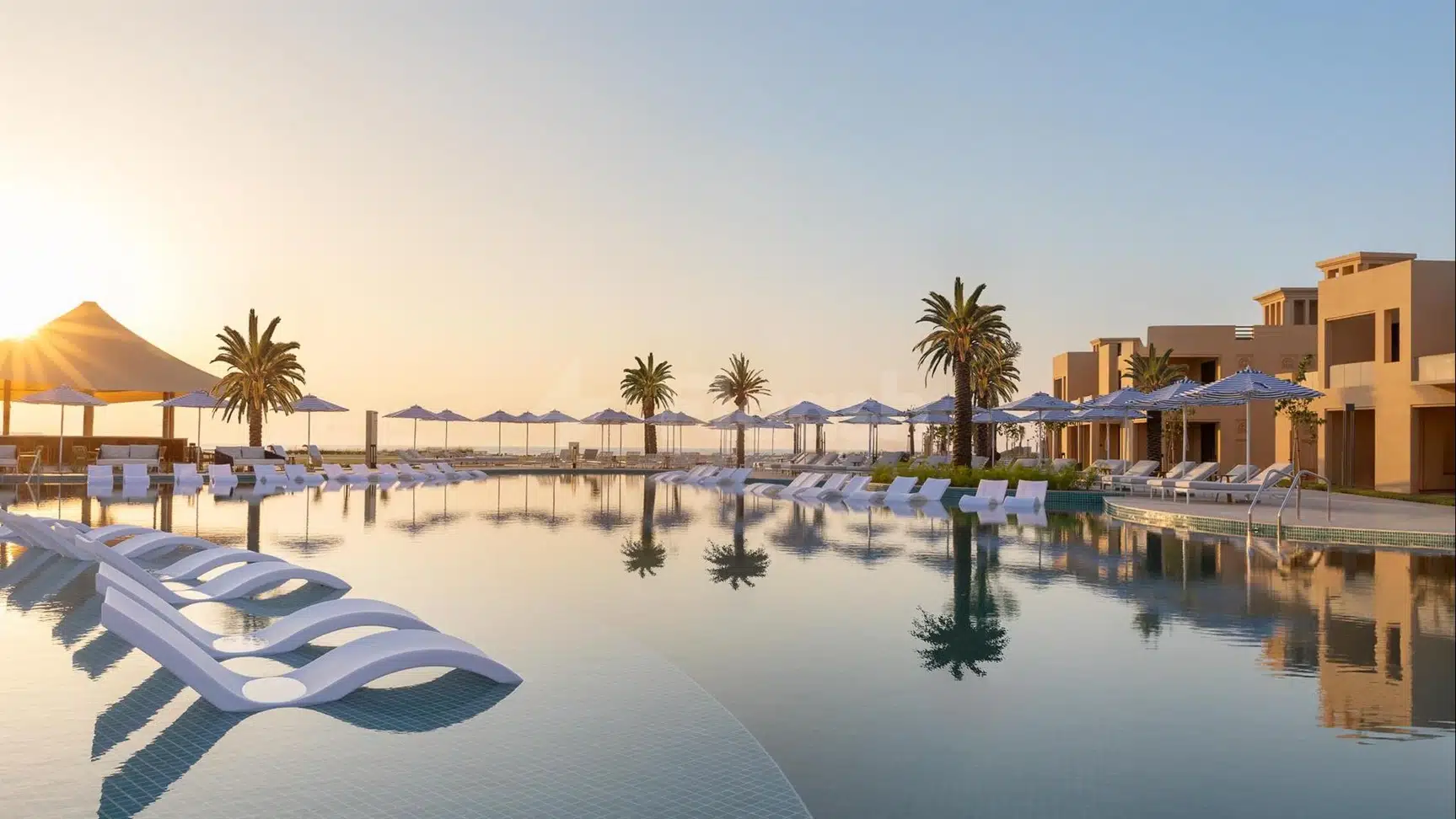 Infinity pool at Sofitel Al Hamra Beach Resort, Ras Al-Khaimah, with floating loungers and palm trees reflected