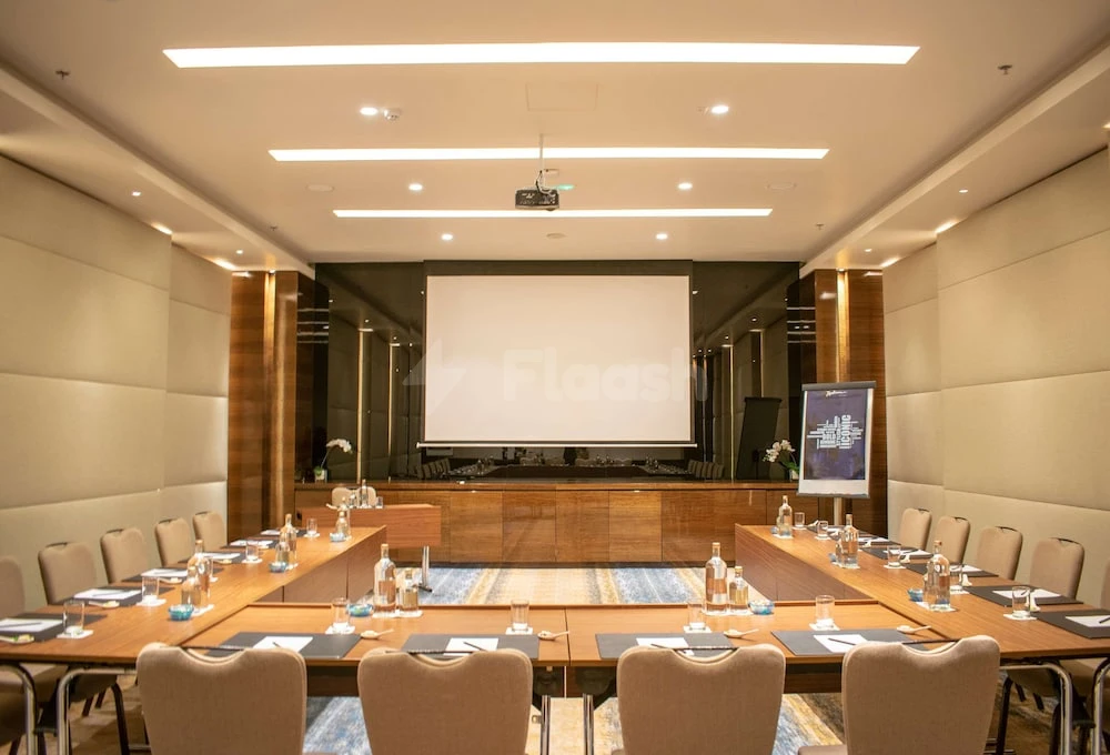 Conference room at Radisson Blu Hotel Ajman, with wooden paneling and large projection screen