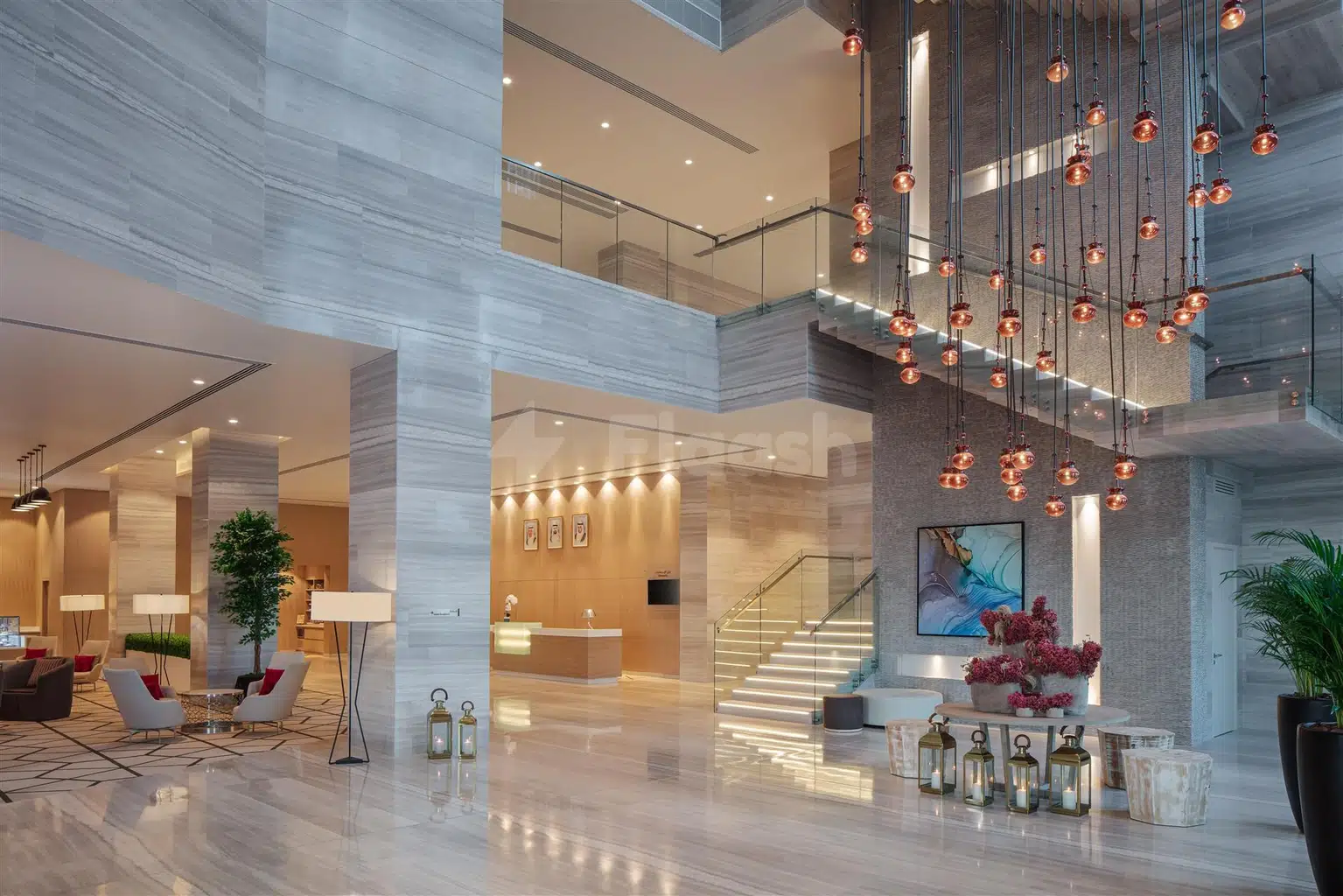 Lobby at DoubleTree by Hilton Fujairah City, Fujairah, with cascading copper pendant lights and marble flooring