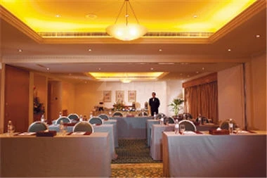 Banquet hall at The Cove Rotana Resort, Ras Al-Khaimah, with golden ceiling lights and table arrangements