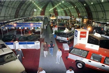 Expo Centre Sharjah, Sharjah, featuring vintage cars on display under a high arched ceiling with bright overhead lights