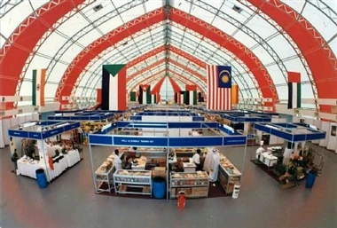 Expo hall at Expo Centre Sharjah, Sharjah, with red-and-white arched ceiling and international flags
