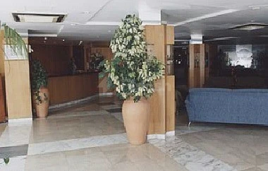 Lobby at Ajman Beach Hotel, Ajman, features large terracotta pots with lush greenery and marble flooring