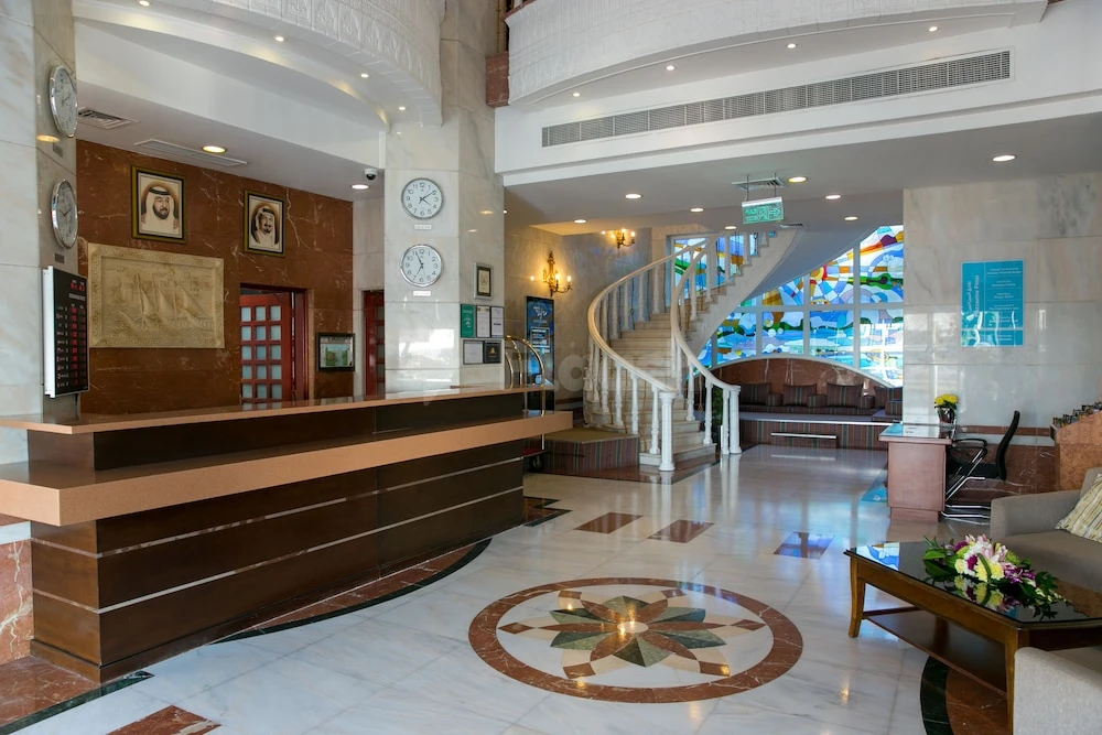 Marble lobby at Ramada by Wyndham Beach Hotel Ajman, Ajman, with spiral staircase and mosaic floor design
