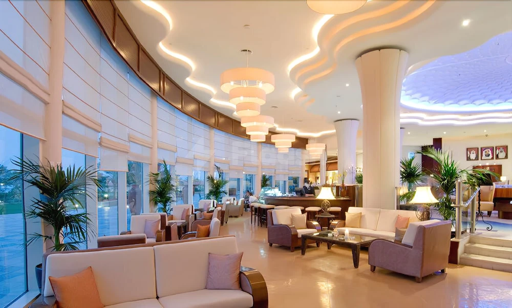 Modern lounge space at Danat Jebel Dhanna Resort, Abu Dhabi, with curved ceiling lights and plush seating