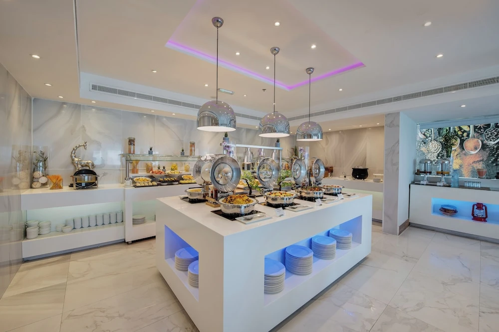 Buffet area at Hawthorn Suites by Wyndham Abu Dhabi City Center, Abu Dhabi, with white marble floors