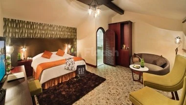 Bedroom suite at Bin Majid Beach Resort, Ras Al Khaima, featuring arched doorway and patterned rug