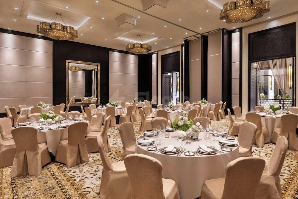 Banquet hall at The Ritz-Carlton Ras Al Khaimah, Al Wadi Desert, with round tables, beige chair covers