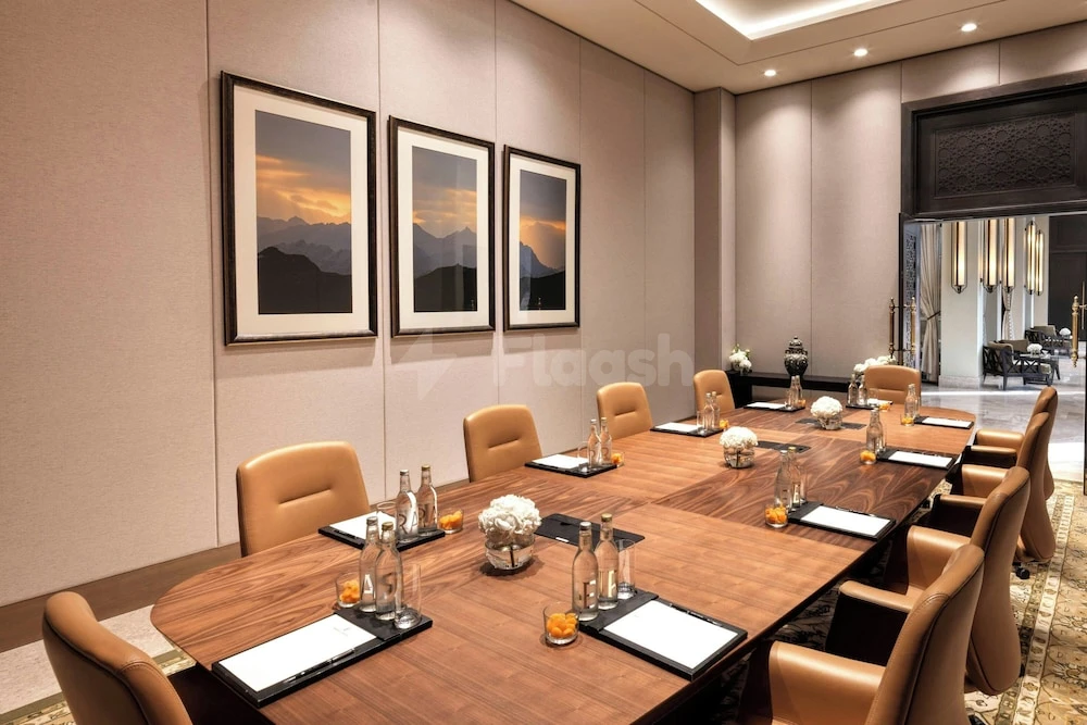 Boardroom at The Ritz-Carlton Ras Al Khaimah, Al Wadi Desert, with framed desert landscapes and leather chairs