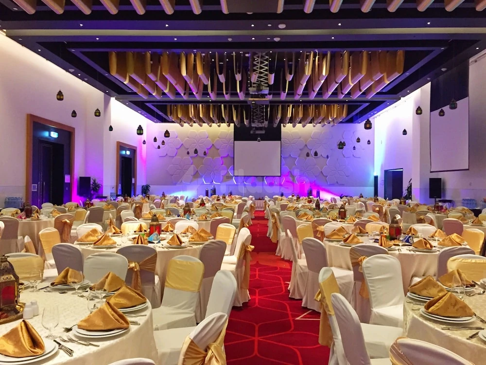 Banquet hall at Crowne Plaza Abu Dhabi - Yas Island, Abu Dhabi, with gold draped chairs and geometric ceiling