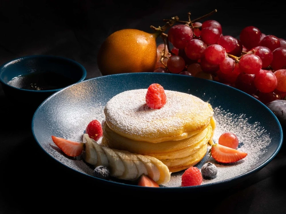 Pancake stack at Majlis Grand Mercure Residence Abu Dhabi, Abu Dhabi, with fresh fruit garnish