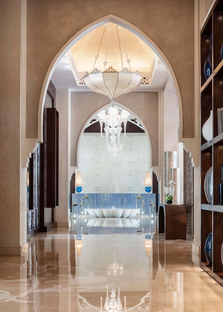 Marble lobby at One&Only The Palm, Dubai, with arched ceiling and crystal chandelier