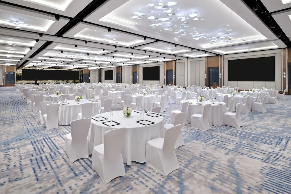 Ballroom at InterContinental Dubai Festival City, Dubai, with white linens and patterned carpeting