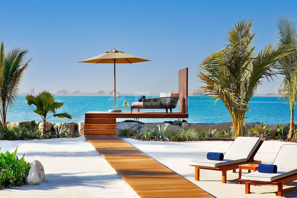 Beachside lounge at The Ritz-Carlton Ras Al Khaimah, Al Hamra Beach, Ras Al Khaimah, featuring wooden deck