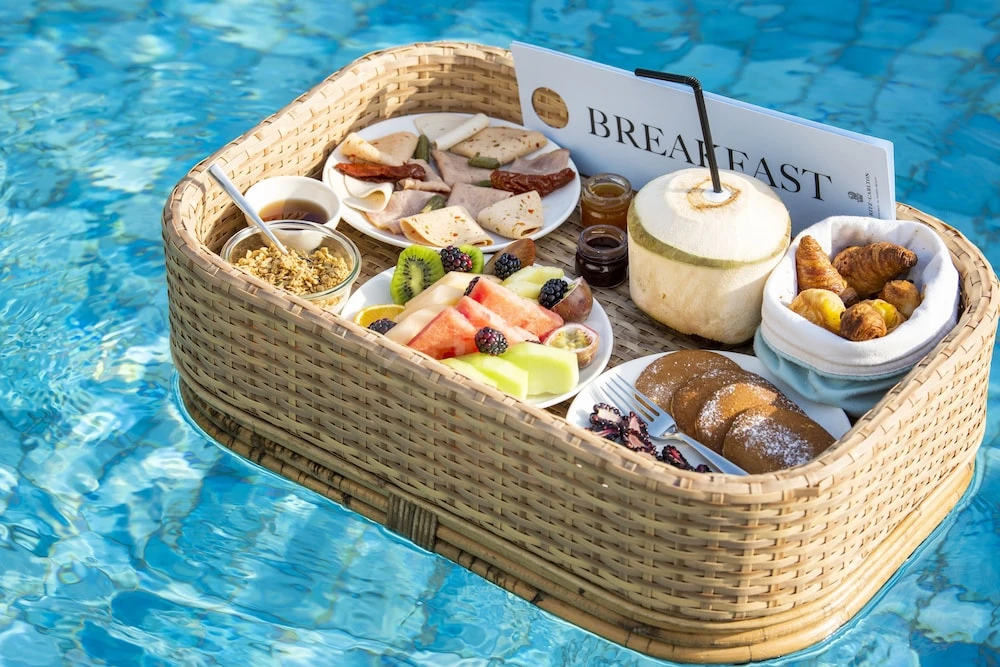 Floating breakfast tray at The Ritz-Carlton Ras Al Khaimah, Al Hamra Beach, Ras Al Khaimah, with coconut drink