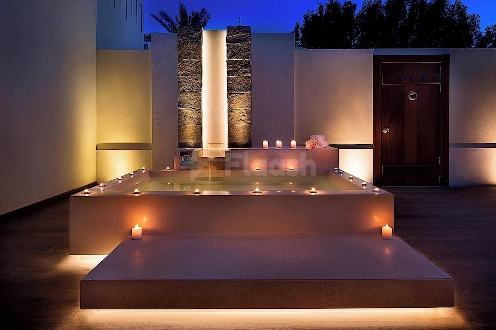 Outdoor spa pool at The Ritz-Carlton Ras Al Khaimah, Al Hamra Beach, Ras Al Khaimah, illuminated by candles