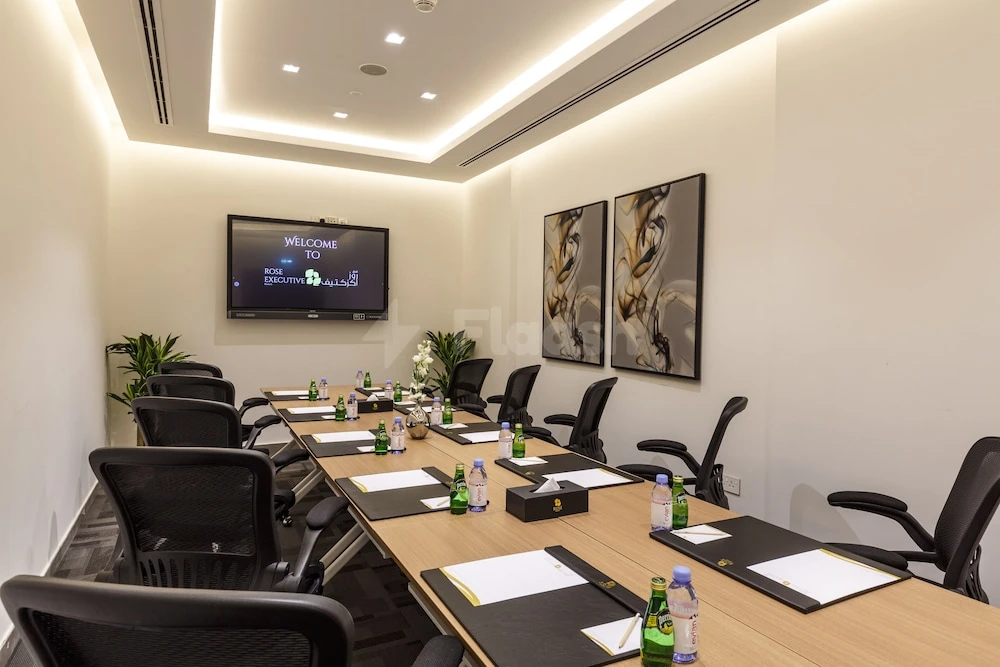 Conference room at Rose Executive, Dubai, with abstract art panels and digital welcome screen