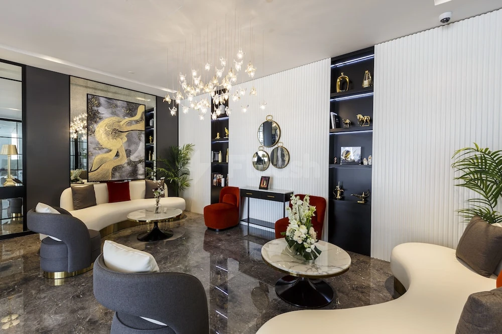 Lounge at Rose Executive, Dubai, with sculptural lighting and gold-accented abstract artwork