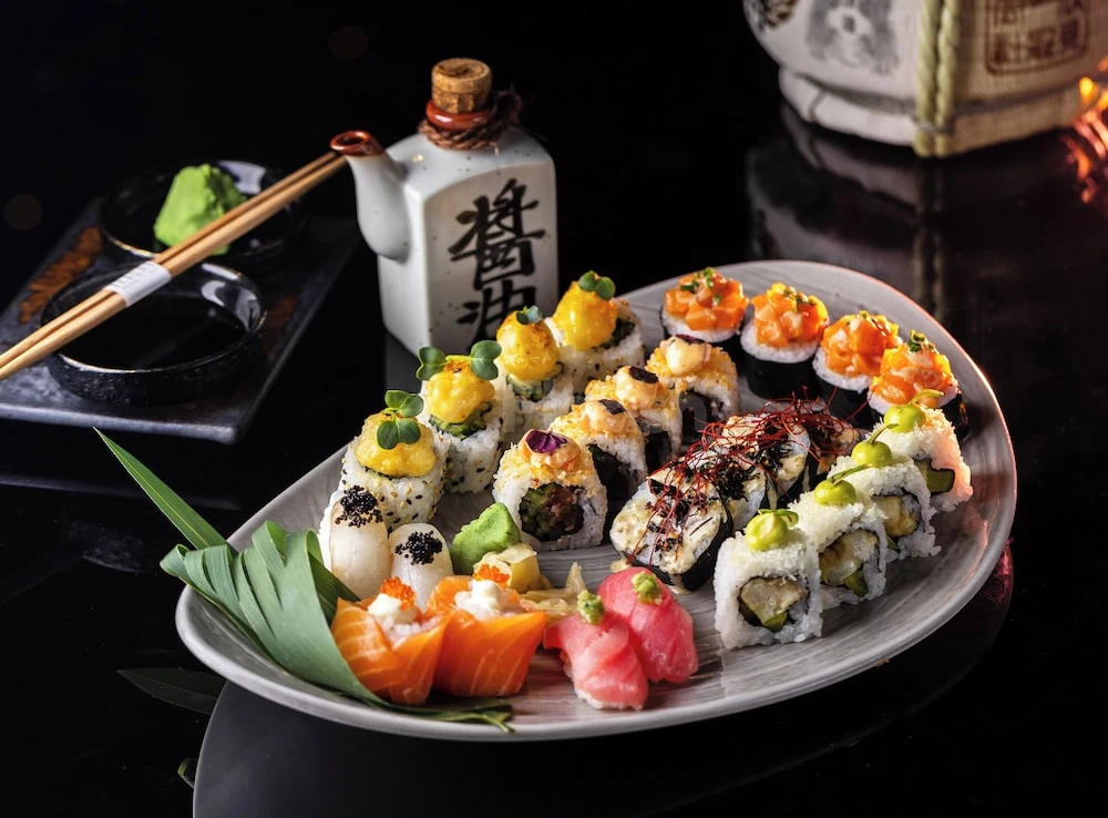 Sushi platter at Millennium Place Marina, Dubai, with wasabi and soy sauce set alongside a ceramic sake bottle